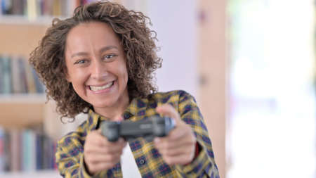 Portrait of Indian Woman Playing Video Gameの写真素材