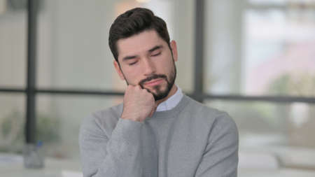 Portrait of Sleepy Young Man taking Nap in Office