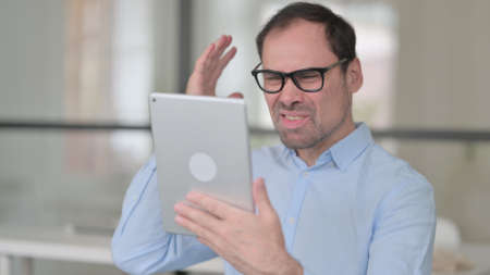 Middle Aged Man having Loss on Tablet