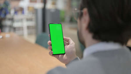 Close up of Man Using Smartphone with Green Chroma Key Screenの写真素材