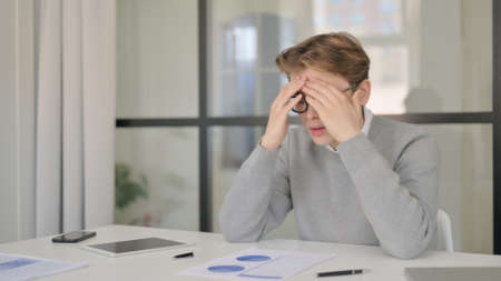 Tense Young Man Feeling Sad after Reading Contract
