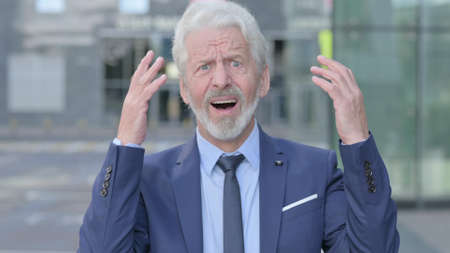 Old Businessman Reacting to Loss, Outdoorの写真素材