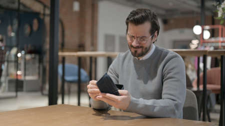 Man Checking Empty Wallet in Office, Crisis