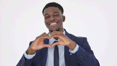 African Businessman showing Heart Shape by Hands on White Backgroundの写真素材