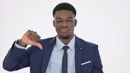 Thumbs Down Gesture by African Businessman on White Background