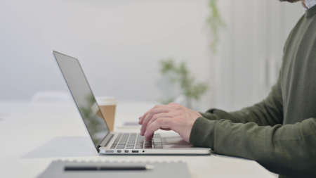 Close up of Young Businessman Working on Laptop