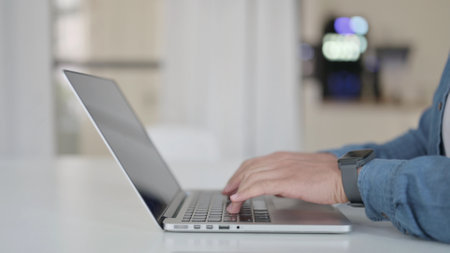 Hands of Man Typing on Laptop