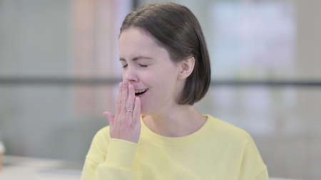 Portrait of Sleepy Young Woman Yawning