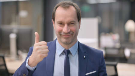 Portrait of Businessman showing Thumbs Up Signの写真素材