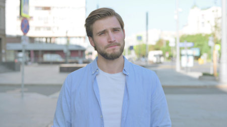 Rejecting Man Shaking Head in Denial Outdoor