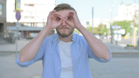 Outdoor Young Man Searching with Handmade Binocular