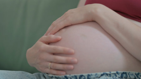 Close Up of Pregnant Woman Stokes Her Big Bellyの写真素材