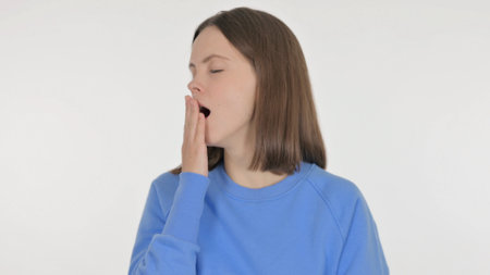 Tired Casual Woman Yawning on White Backgroundの写真素材
