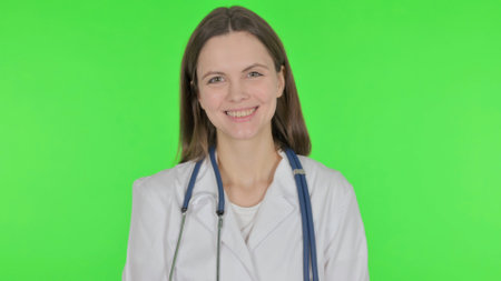 Smiling Young Doctor on Green Backgroundの写真素材