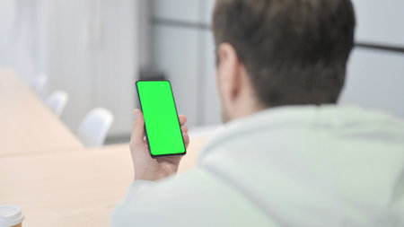 Young Adult Man Using Smartphone with Green Screen