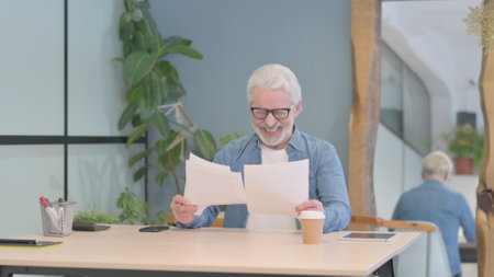 Senior Old Man Reading Documents at Work, Paperworkの写真素材
