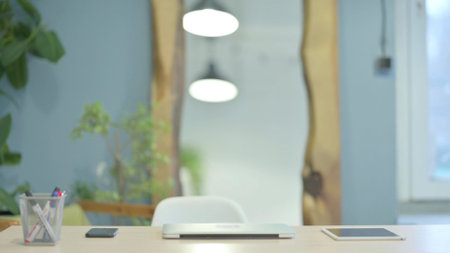 Young Woman Coming to Work, Typing on Laptopの写真素材