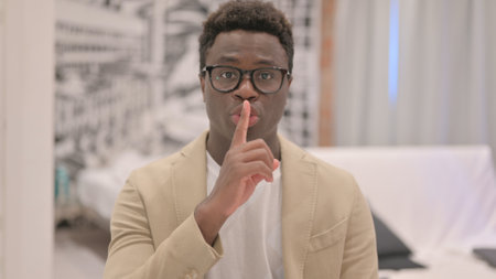 Portrait of Mature Adult Man with Finger on Lips