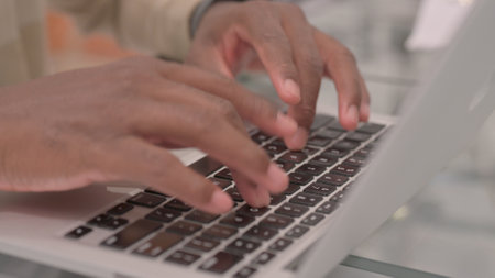 Close Up of Man Typing on Laptop