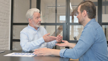 Two business people discussing in officeの写真素材