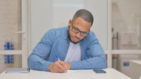 Mixed Race Man Writing a Letterの写真素材