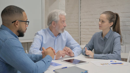 Close up of Businessman Talking with Teammatesの写真素材