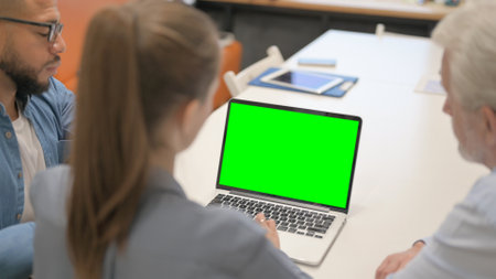 Teammates Using Laptop with Green Screen