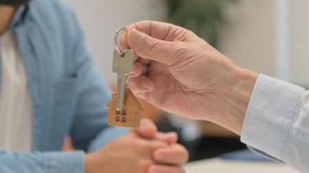 Close Up of Old Man Giving Home Keysの写真素材