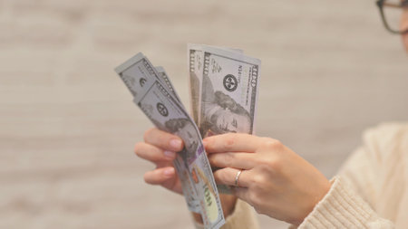 Close up of Female Counting Money in Officeの写真素材