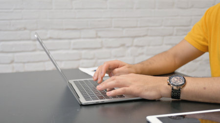 Side View of Man Typing on Laptop