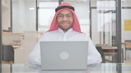 Smiling Young Muslim Man at Workの写真素材