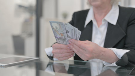 Close up of Old Woman Counting Money