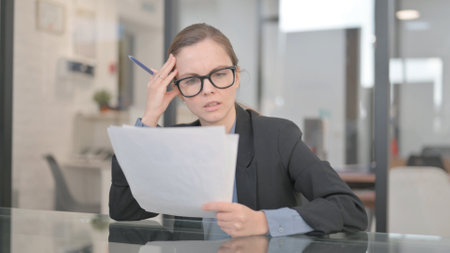 Reading Businesswoman Upset with New Contract Detailsの写真素材