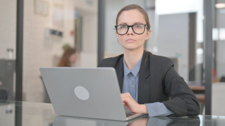 Businesswoman Looking at Camera while in Officeの写真素材