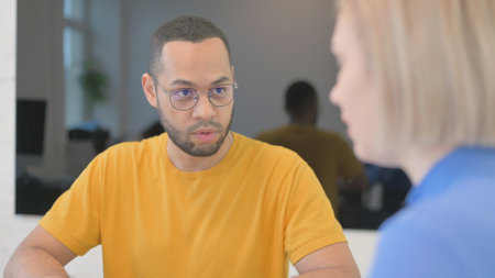 Mixed Race Man Talking with Young Womanの写真素材