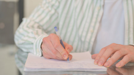 Close up of Man Writing a Letterの写真素材