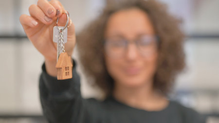 Close up of Female Hand Showing Home Keyの写真素材