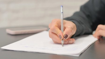 Close up of Female Hand Writing a Letterの写真素材