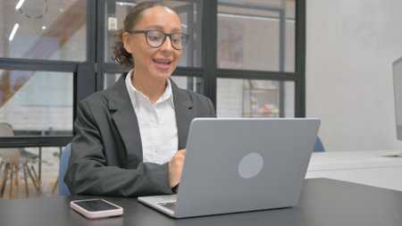 Hispanic Business Woman Talking with Customer Online, Video Conferenceの写真素材