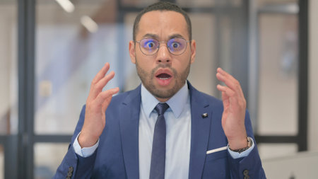 Portrait of Mixed Race Businessman Feeling Upset for Lossの写真素材