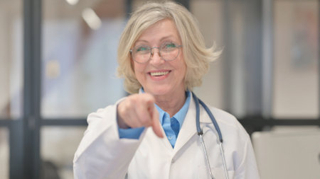 Portrait of Doctor Pointing at Cameraの写真素材