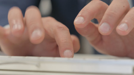Close up of Male Fingers Typing on Keyboardの写真素材