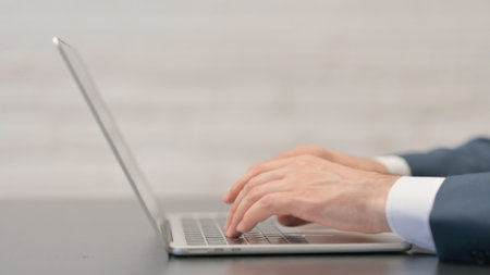 Close up Male Hands Typing on Laptop