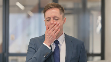 Portrait of Yawning Tired Young Businessmanの写真素材