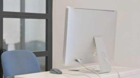 Mature Adult Man Leaving Office after Working on Desktop Computer