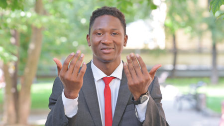 Inviting Gesture by African Businessman Outdoorの写真素材