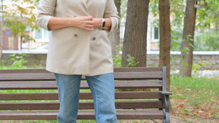 Senior Woman Standing and Leaving after Sitting in Parkの写真素材