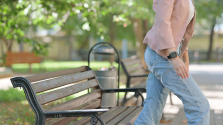 Casual Business Woman Standing and Leaving after Sitting Outdoor on Benchの写真素材