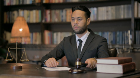 Upset Young Lawyer Counting Money in Courtroomの写真素材