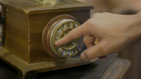 Close up of Fingers Dialing Vintage Phoneの写真素材